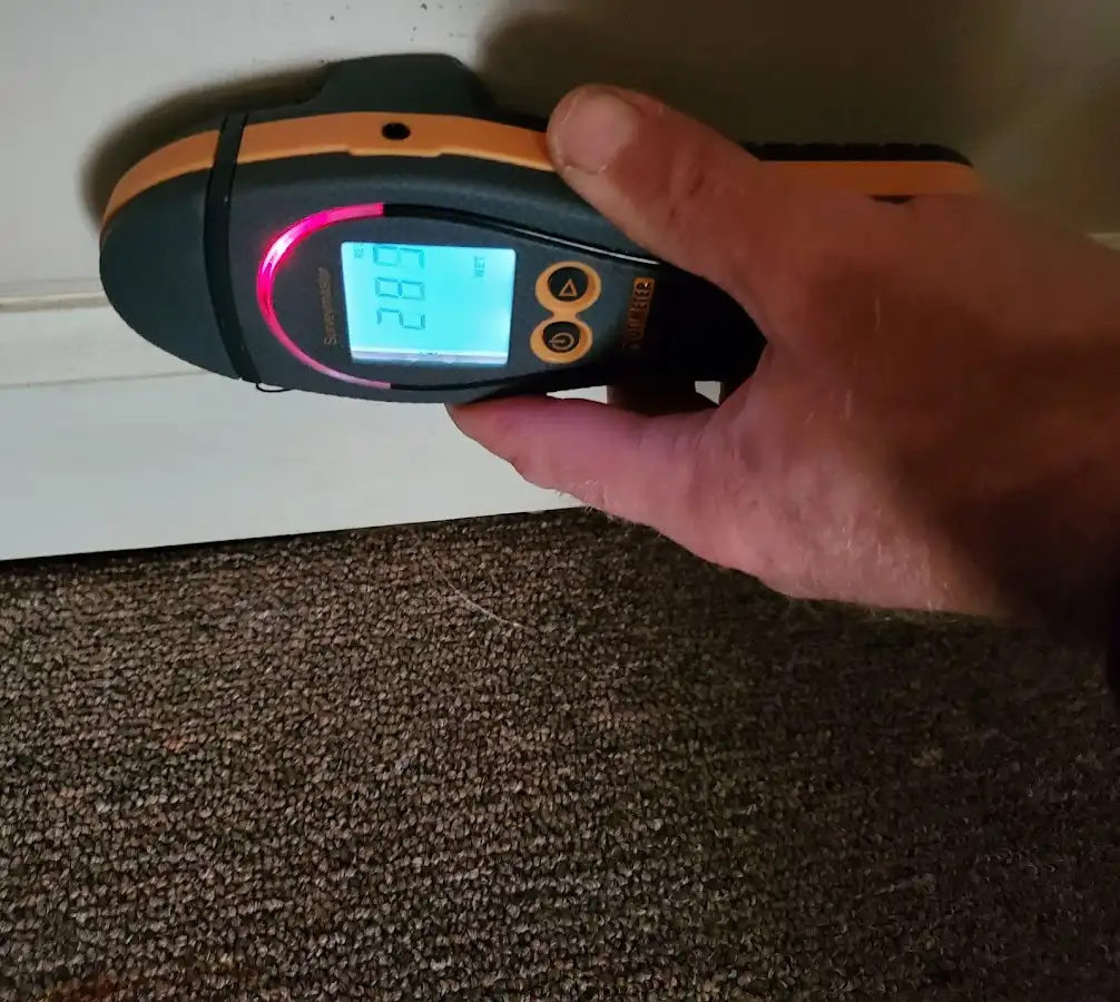 Moisture detection at baseboard during Storm Damage Restoration in Battlefield